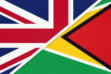 United Kingdom vs Guyana national flag from textile. Relationship between two european and american countries.