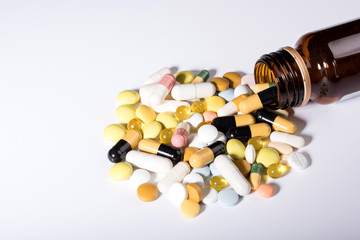 Pills spilled out of pill bottle, top view. Medication and medicine tablets. Copy space.