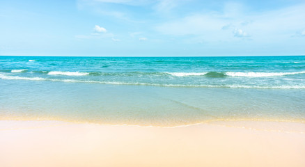 Clean white beach golden brown sand and blue sea under clear blue sky in a sunny day