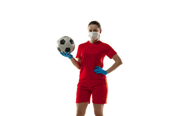 Competition. Female football player in protective mask and gloves. Prevention against pneumonia. Still active while quarantine. Chinese coronavirus treatment. Healthcare, medicine, sport concept.