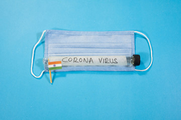 Corona Virus in India Indian flag with Corona Virus label on test tube with a surgical on blue background Covid-19 Global Epidemic