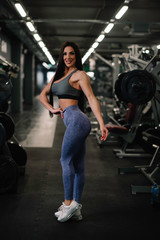 Fototapeta na wymiar Fitness woman on training. Young woman in the gym.
