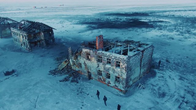 People walk around the ruins