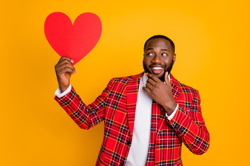 Photo of cute cunning dark skin guy hold hand paper heart shape think over girlfriend romance plan...