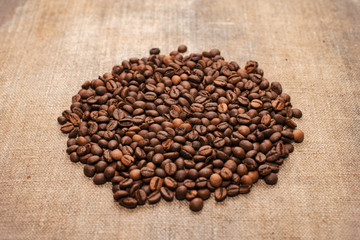 Coffee beans on a rough cloth on the table