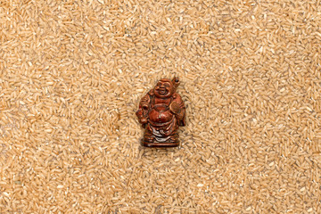 Wooden figure of netsuke and white rice. Asian culture