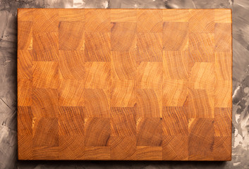 Composition with a cutting board on a textured plastered surface