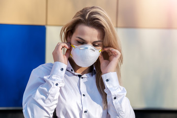 Young Beautiful Blonde Caucasian Woman Standing in a Protective Mask.