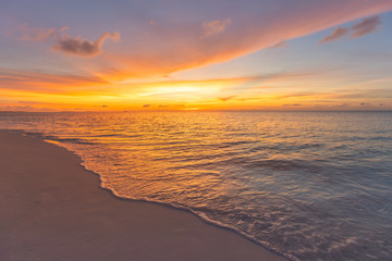 Closeup of sand on beach and blue summer sky. Panoramic beach landscape. Empty tropical beach and seascape. Orange and golden sunset sky, soft sand, calmness, tranquil relaxing sunlight, summer mood