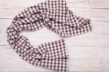 Tablecloth napkin on wood texture. Rustic background. top view.