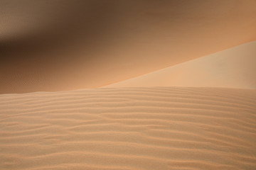 Abstract landscape with desert dunes on a sunny day. Liwa desert, Abu Dhabi, United Arab Emirates.
