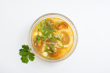 Tom yum (Tom Yam) soup with chicken and squid on top on white background