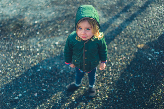 Little preschooler standing outdoors in winter