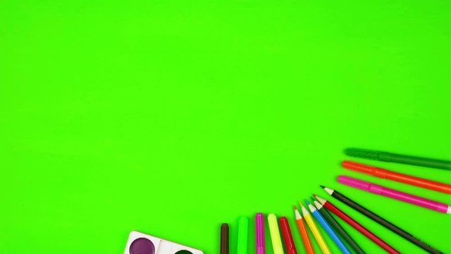 Concept on the theme of back to school, school education, stationery. Chroma key appears, colored pencils, felt-tip pens, watercolor paints. Flatley, stop motion. There is copyspace