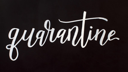 Obraz premium Chalk inscription QUARANTINE on a black chalkboard