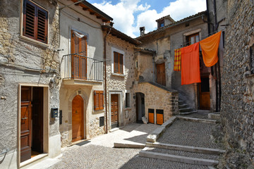 Fototapeta na wymiar A narrow street between the old houses of a medieval village in Abruzzo