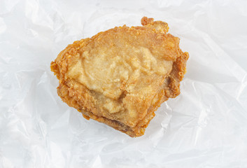 Batter-fried chicken isolated on cooking oil absorbing paper (clipping path included)