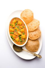 Aloo Puri or Potato curry with fried Poori, popular Indian breakfast / lunch / dinner menu.