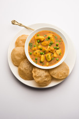 Aloo Puri or Potato curry with fried Poori, popular Indian breakfast / lunch / dinner menu.