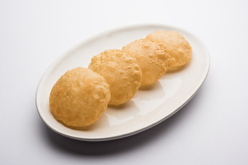 Plain Puri served in a plate. It's an Indian deep-fried bread made from whole-wheat flour, popular main course or breakfast recipe 