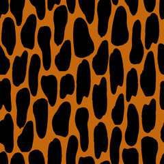 Vector seamless pattern of leopard spots.Abstract black texture in a modern style on an orange background.Ornament for textiles, camouflage, wrapping paper.