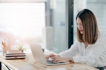 Fototapeta premium Young businesswoman working with laptop at modern office.
