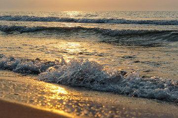 Sunset over the sea. Reflection of sunlight in the sea waves. The sky in the sunset rays.