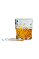 Old Fashioned Whiskey is contained in a crystal lowball glass. The showy illustrative picture is made on the white backdrop.