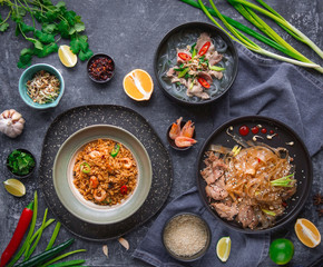 Asian Cuisine, Spicy Asian Beef Noodles, Pho Bo and seafood rice on dark background