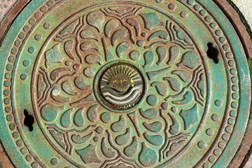 Metal lid of a sewer on the street