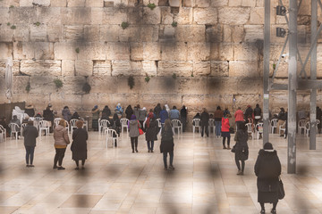View through the perforated metal enclosure to the female part of the Western Wall in the Old Town...