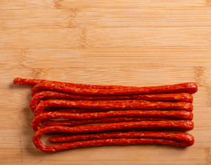 Thin smoked sausages are on the table.