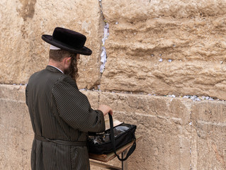 Believer Orthodox Jew prays near the Kotel in the Old Town of Jerusalem in Israel