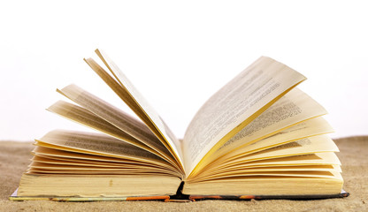 An open book lies on the table on a white background.
