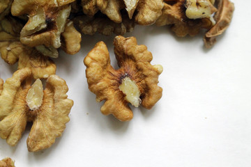Peeled walnuts on a white background. Tasty and healthy.