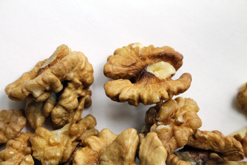 Peeled walnuts on a white background. Tasty and healthy.