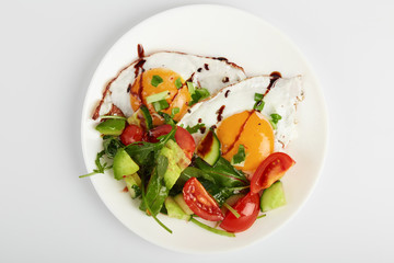 healthy breakfast . Omelette with avocado salad cucumber and cherry tomatoes