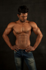 Fototapeta na wymiar Tanned trainer body builder posing chest athletic body