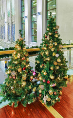 Fototapeta na wymiar Two Christmas trees displayed at the Galerija Centrs in Riga
