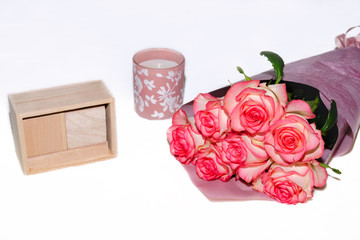 roses in a beautiful bouquet on a light background, calendar and candle, holiday gift