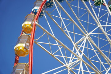 Carousel. Ferris Wheel on a blue background. Carriages of the big wheel - 331205052