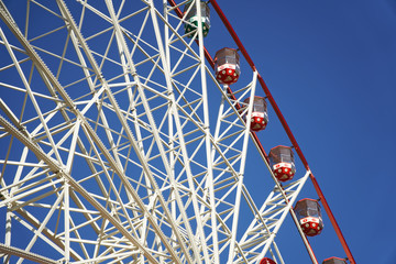 Carousel. Ferris Wheel on a blue background. Carriages of the big wheel - 331205074