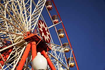 Carousel. Ferris Wheel on a blue background. Carriages of the big wheel - 331205085