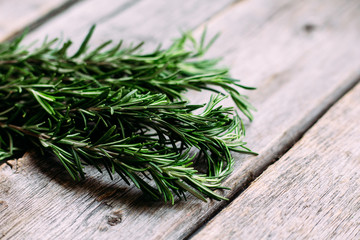 A bunch of fresh rosemary on the table.