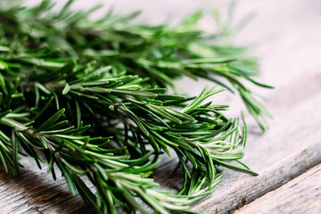 A bunch of fresh rosemary on the table.