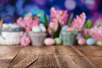 Obraz na płótnie Canvas Easter background. Rustic wooden table. Tulips and spring flowers. Easter eggs. Pastel colors bokeh. 