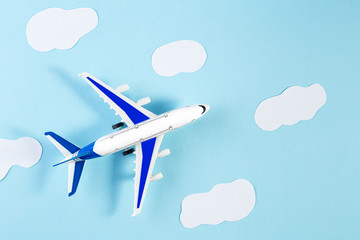 Model plane, airplane on blue pastel color background. Summer travel or vacation concept. Flat lay of miniature toy airplane. trendy minimal style, copy space