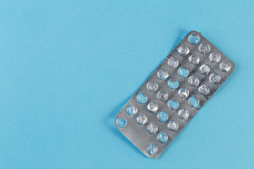 Used blister pack from tablets medicine on blue background. Medical blister pack opened and empty without pills top view. Medical and healthcare concept.