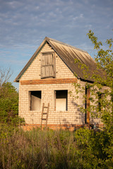 Fototapeta na wymiar Old Abandoned brick house in garden