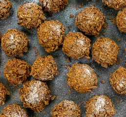 chocolate truffle on black plate